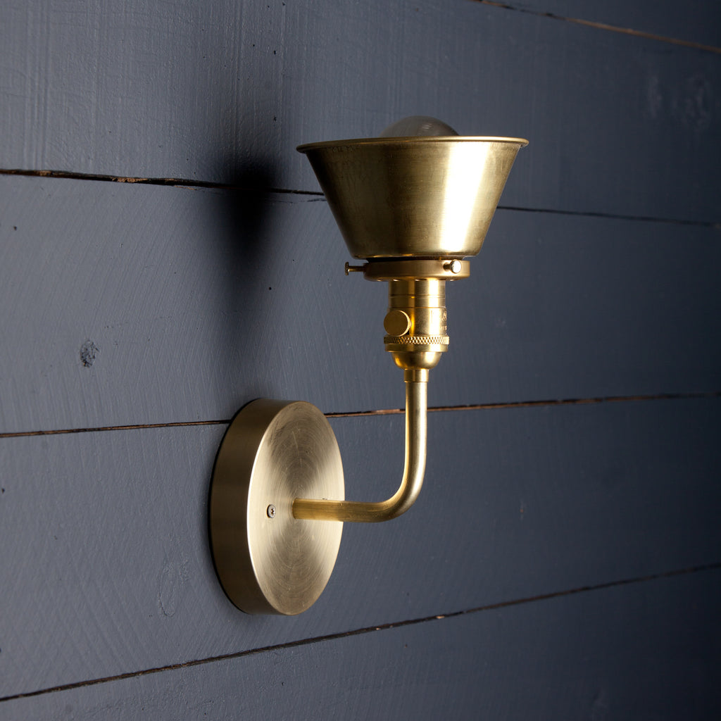 A handcrafted finish for raw brass wall light